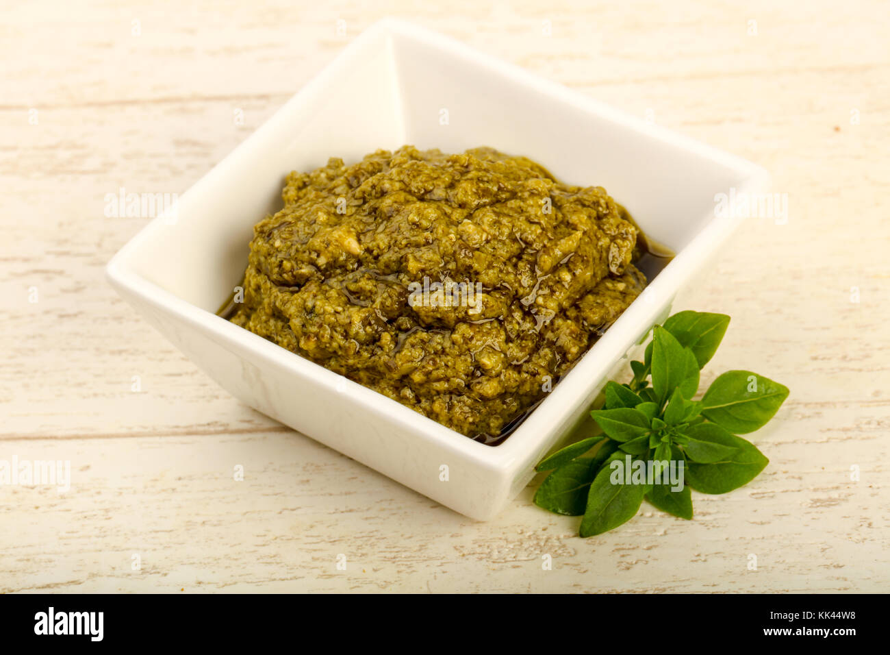 Pesto sauce with basil leaves in the bowl Stock Photo Alamy