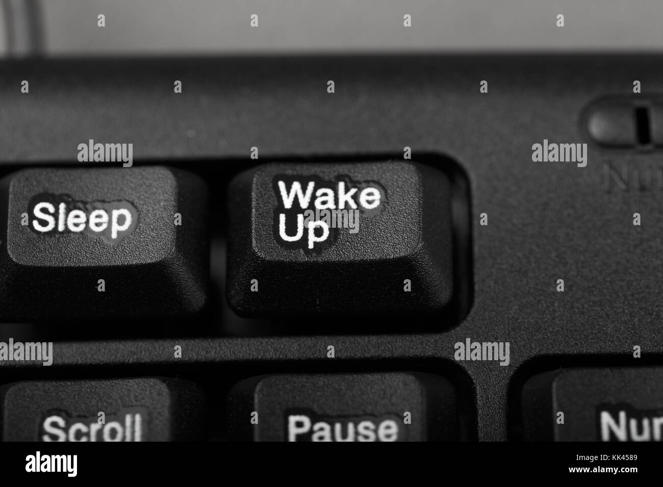 button, wake up and sleep on the keyboard, conceptual photo, close-up Stock Photo
