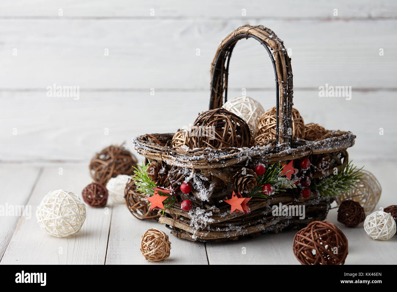 Christmas decorations basket on white planks Stock Photo