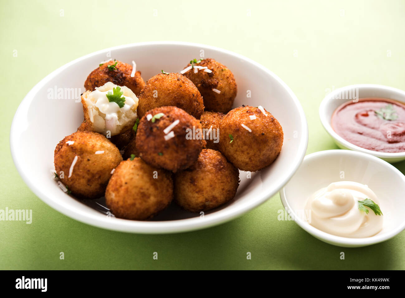 Fried potato cheese balls or croquettes with tomato ketchup. Selective focus Stock Photo