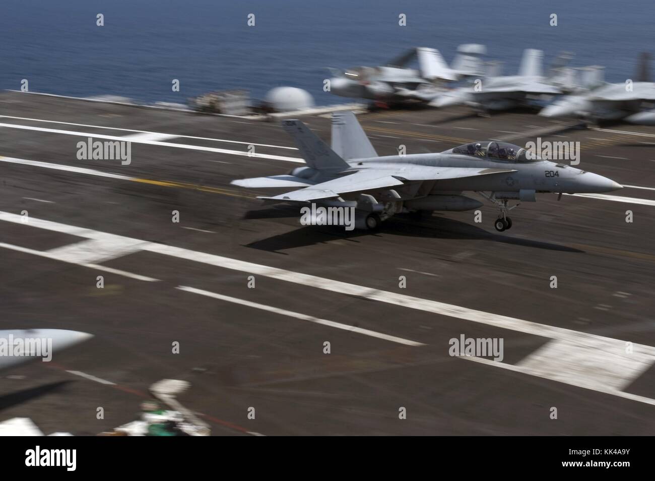 An F/A-18F Super Hornet assigned to the Jolly Rogers of Strike Fighter Squadron VFA 103 lands on the flight deck of Nimitz-class aircraft carrier USS Dwight D Eisenhower CVN 69, Atlantic Ocean, 2012. Image courtesy Mass Communication Specialist 3rd Class Douglas Revell/US Navy. Stock Photo