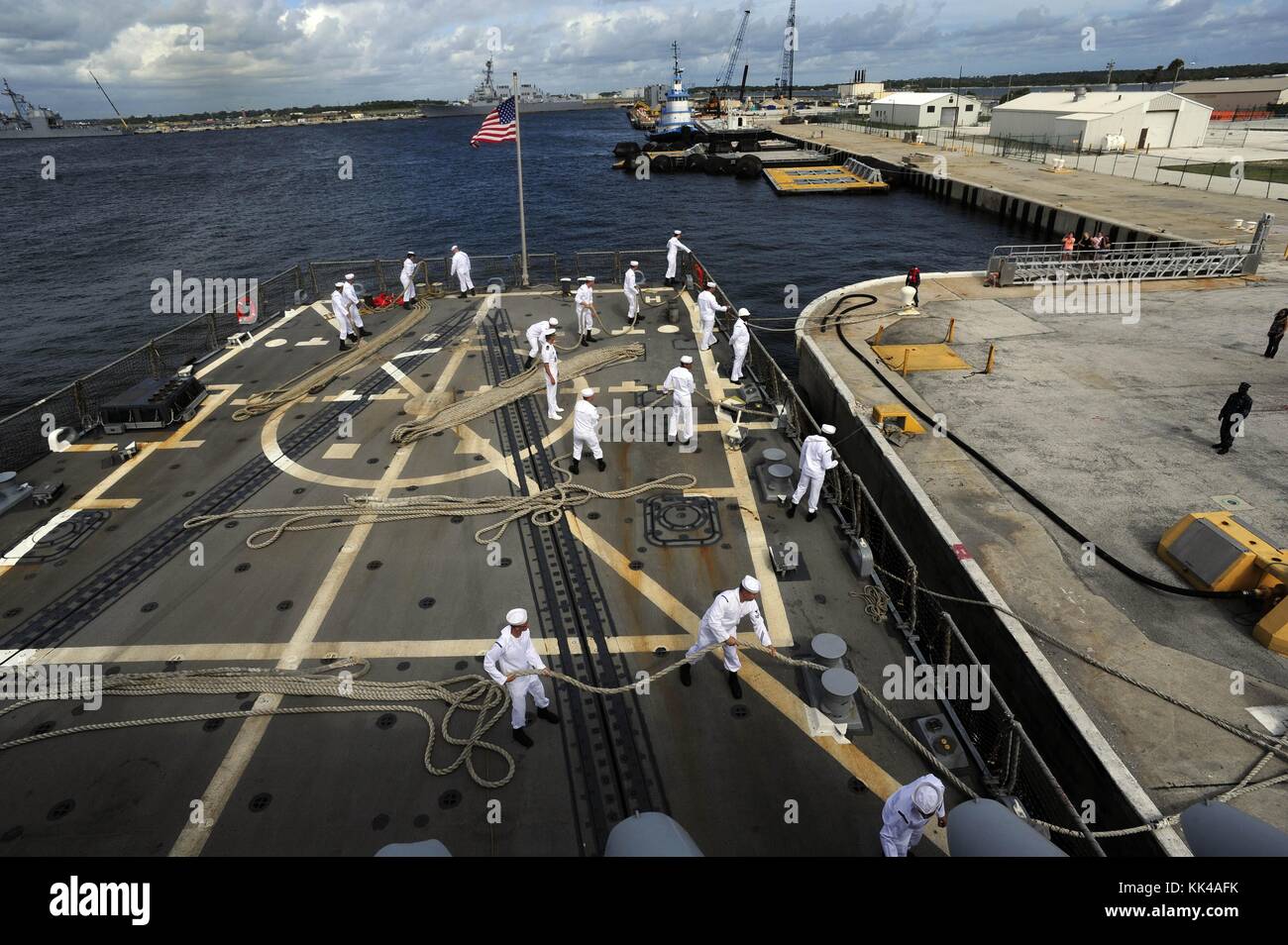 Sailors aboard the guided-missile destroyer USS Farragut DDG 99 heave ...