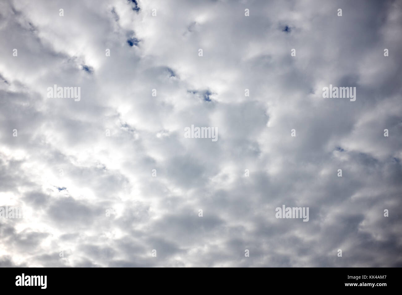 Cloudy overcast sky with cotton wool formations of white fluffy clouds in a dense cloud cover in a full frame view Stock Photo