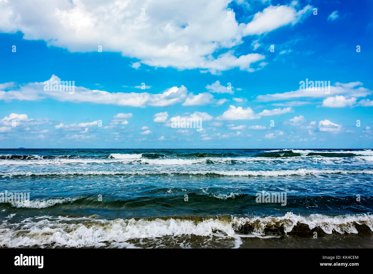 Seascape. Tidal wave, blue sky with clouds and an endless horizon Stock Photo