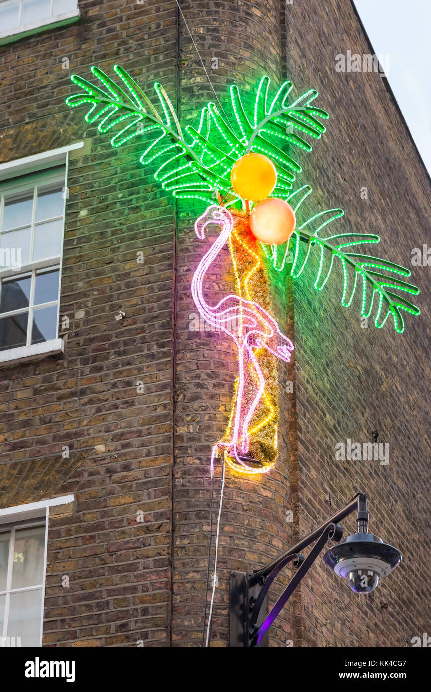 Pink flamingo and palm tree neon lights christmas decoration, part of Carnaby Christmas lights in Newburgh Quarter and Carnaby Street, London Stock Photo