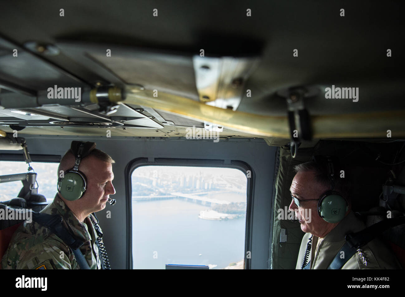 Marine Corps Gen. Joseph F. Dunford Jr., chairman of the Joint Chiefs of Staff, speaks with Army Command Sgt. Maj. John W. Troxell, senior enlisted advisor to the chairman of the Joint Chiefs of Staff, during a helo ride aboard an MH-60 Blackhawk above Seoul, Republic of Korea, Oct. 28, 2017. (DOD photo by Navy Petty Officer 1st Class Dominique A. Pineiro) Stock Photo