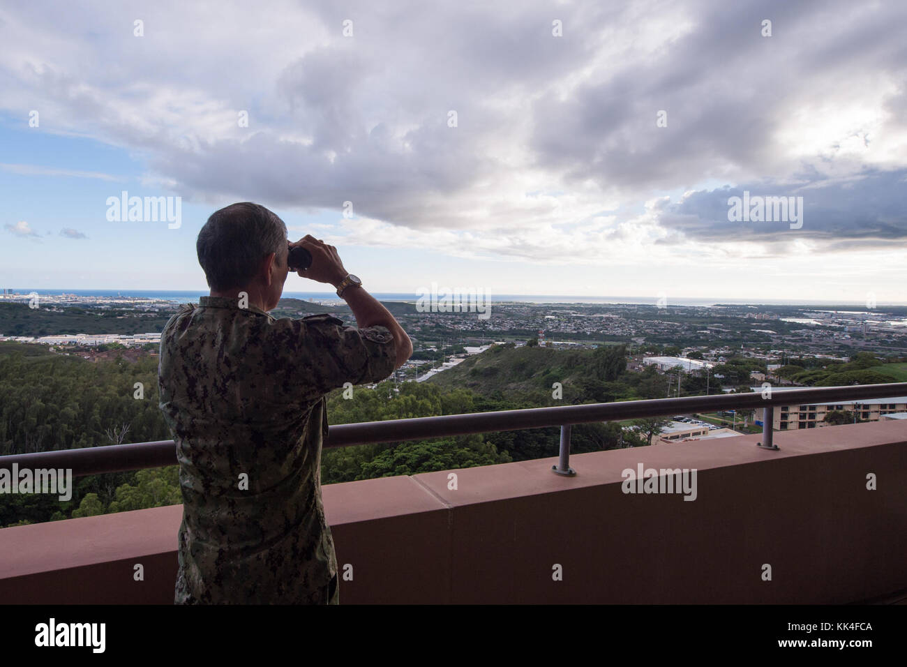 Navy Adm. Harry Harris, Commander, U.S. Pacific Command, looks through binoculars after a trilateral meeting between the U.S., Republic of Korea, and Japan at PACOM headquarters. The session was the fifth between the senior most U.S., ROK and Japanese military officers since July, 2014. The leaders discussed multilateral and bilateral initiatives designed to improve interoperability and readiness as well as North Korea’s recent long-range ballistic missile and nuclear tests and agreed to firmly respond to the acts in full coordination with each other. Dunford reaffirmed the ironclad commitment Stock Photo