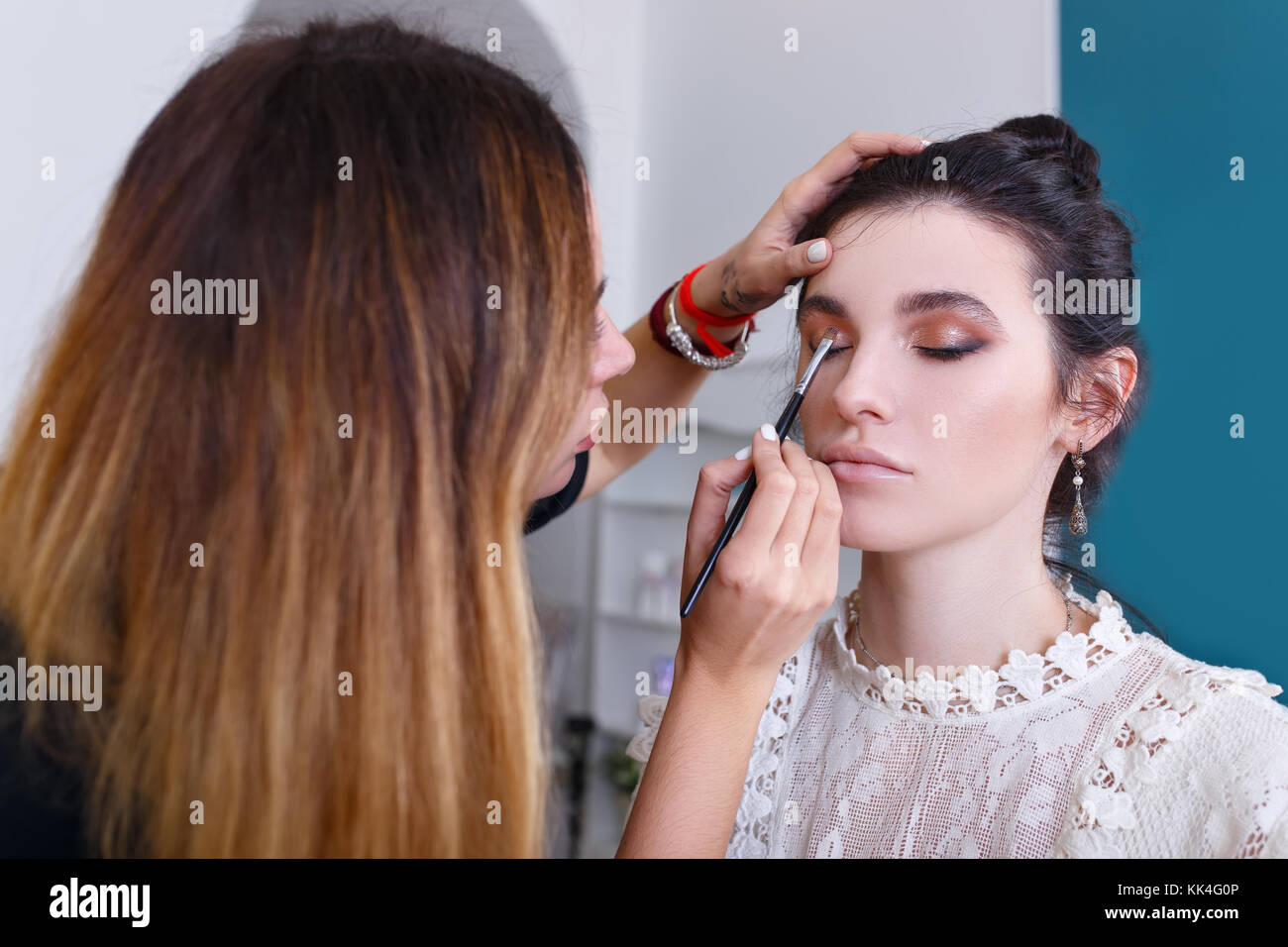 makeup artist doing eye make up Stock Photo