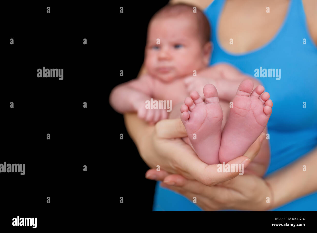 mother hands holding newborn baby Stock Photo