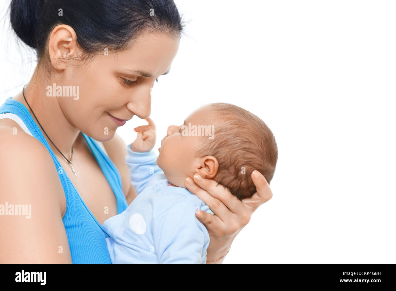 mother holding and kissing newborn baby Stock Photo