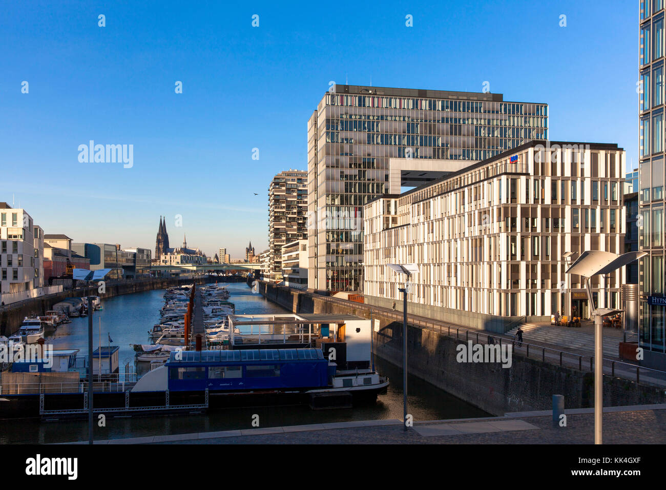 Germany, Cologne, the Rheinau harbour, the office building BF 10 between the Crane Houses, in the background the cathedral.  Deutschland, Koeln, der R Stock Photo