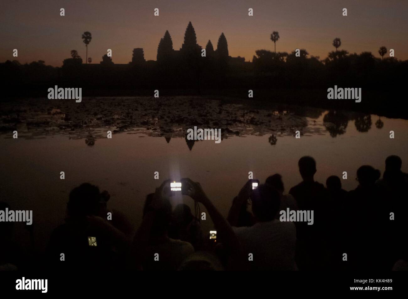 Angkor Wat. -  11/12/2009  -  Cambodia / Angkor  -  Angkor Wat. -  It's still dark but hundreds of tourists are waiting the sunrise ceremony, a pure natural beauty offered by the world. ( it's the same ritual and same wait every day)   -  Sylvain Leser / Le Pictorium Stock Photo