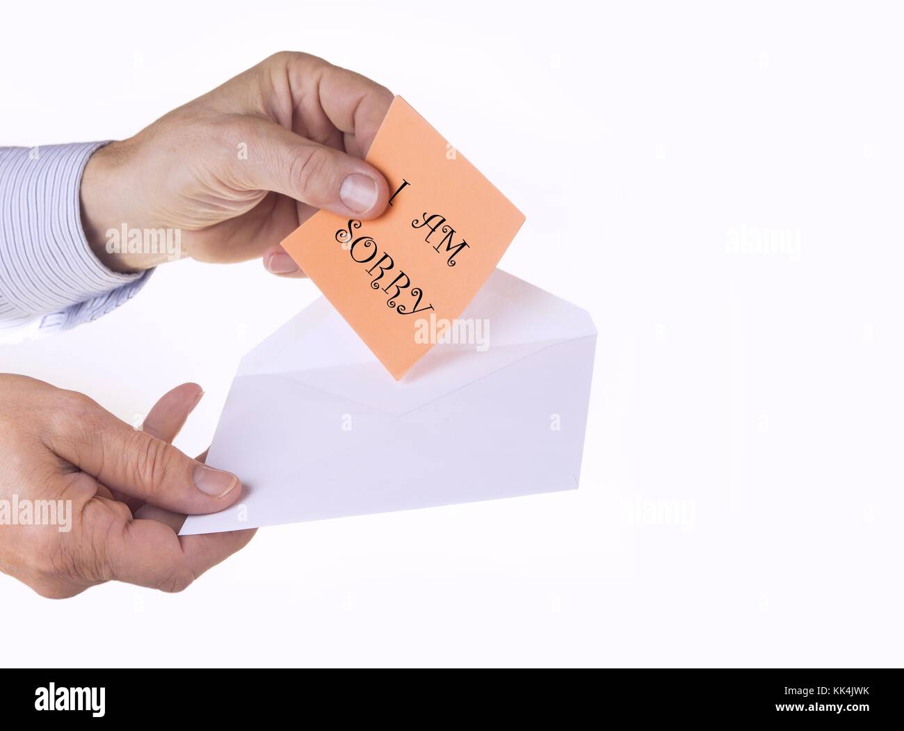 White envelope with paper note with man hand on the white background. I am sorry concept. Stock Photo