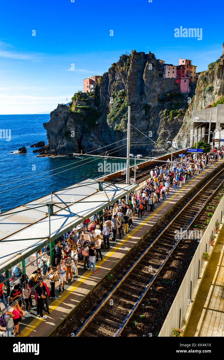 Italy. Liguria. Cinque Terre National Park UNESCO World Heritage Site. Tourists waiting for the train connecting the Cinque Terre villages Stock Photo