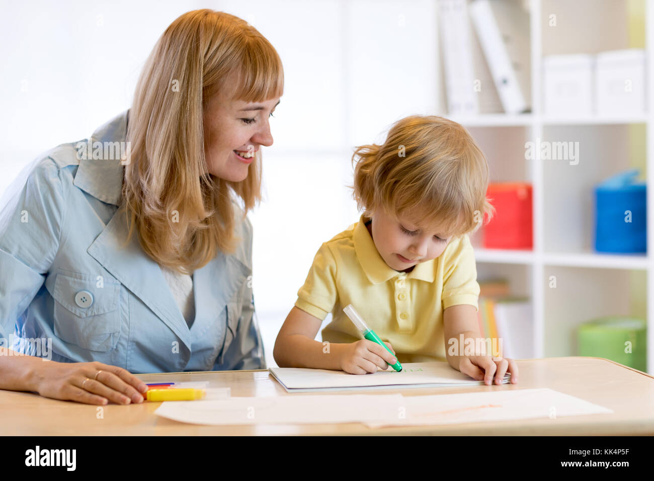 Child drawing with mother Stock Photo - Alamy