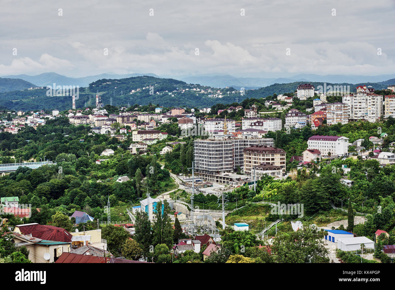 Panorama of Sochi from the air. Houses, streets, trees, the sky are visible. In the distance you can see the sea. Sochi, Russia, cityscape Stock Photo