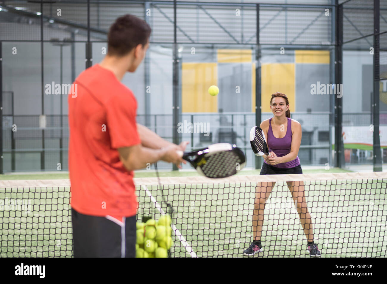 Couple training paddle tennis in court with racket and balls in recreation  activity Stock Photo - Alamy