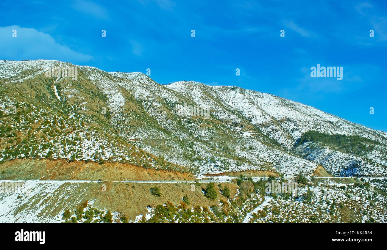 The slopes of Pindus mountains are covered with poor vegetation under the snow, Greece. Stock Photo