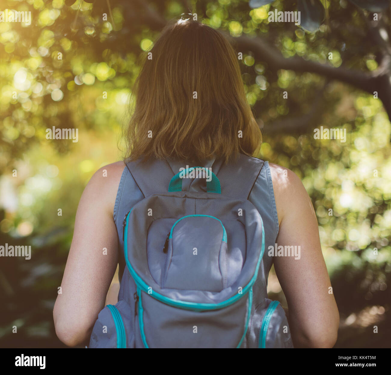Woman with backpack in the forest. View from the back Stock Photo - Alamy