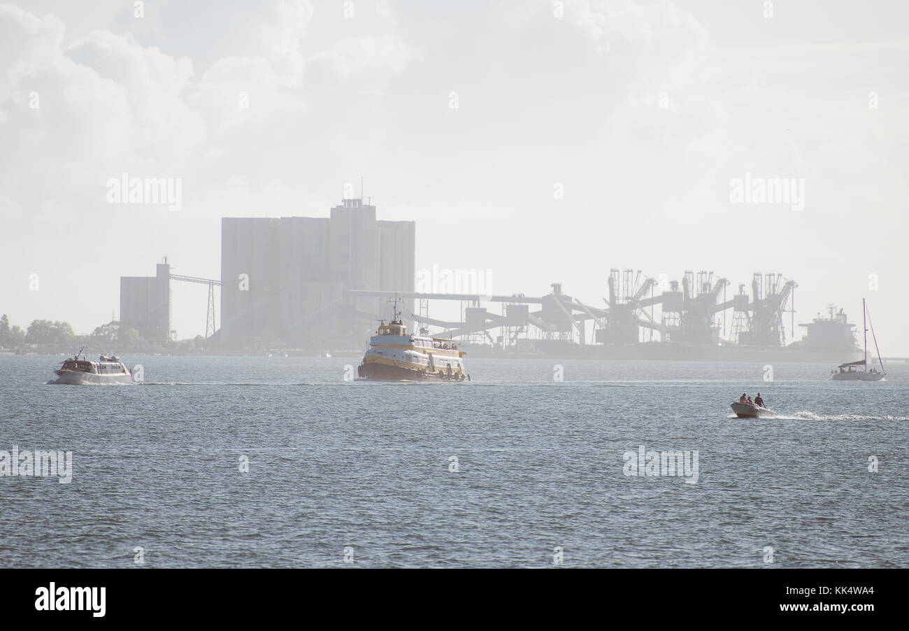 Many ships on Tagus river. Behind the port terminal with cranes Stock ...