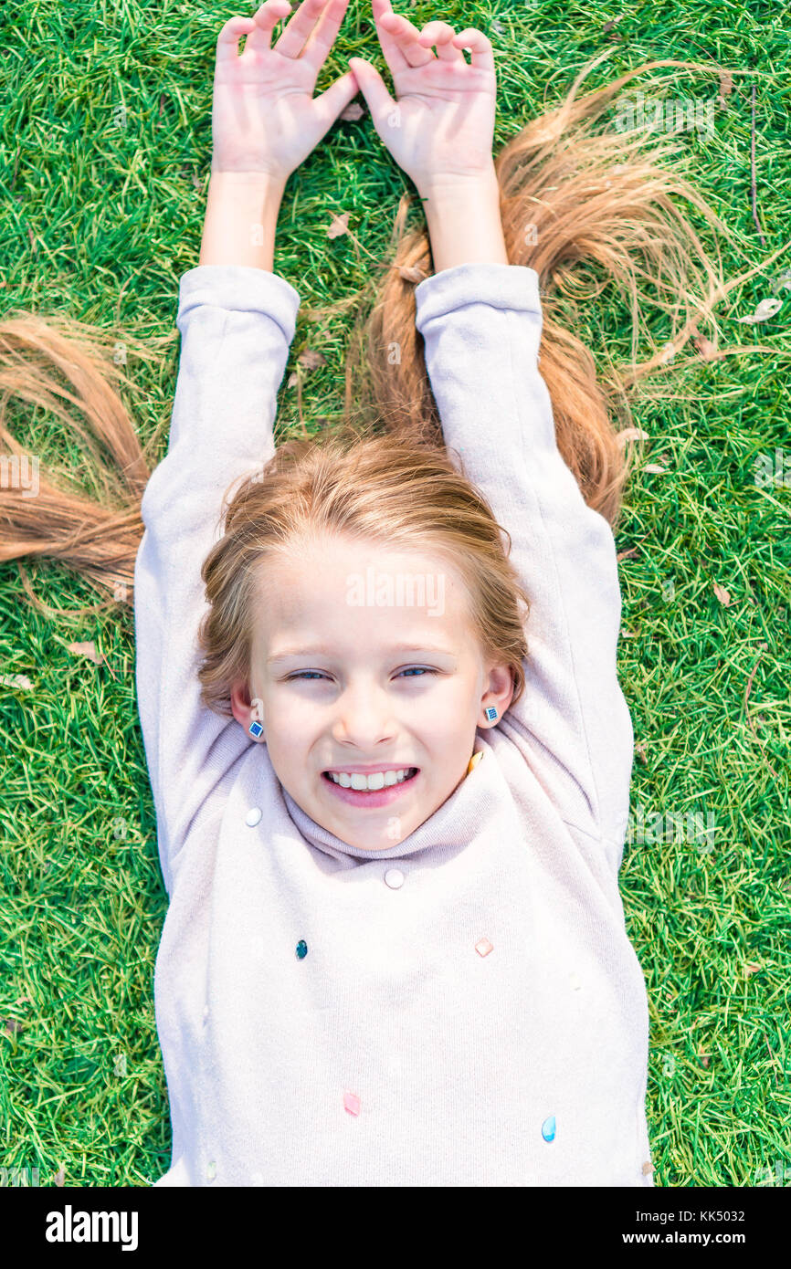 Adorable toddler girl on green grass outdoor Stock Photo - Alamy