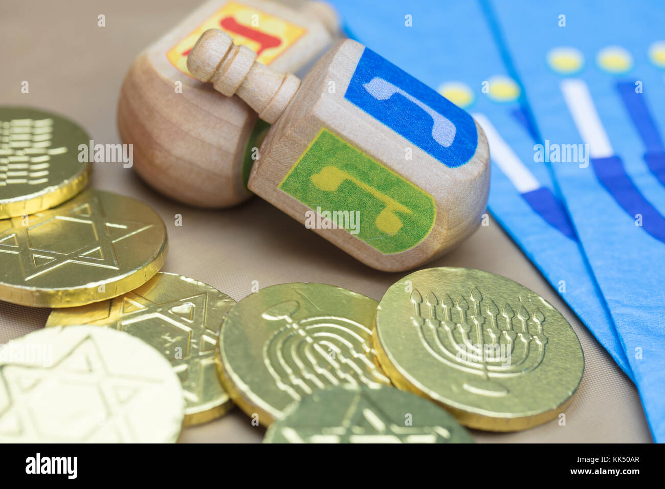 Traditional Hanukkah Dreidels, Napkins and Chocolate Gelt Coins Stock Photo