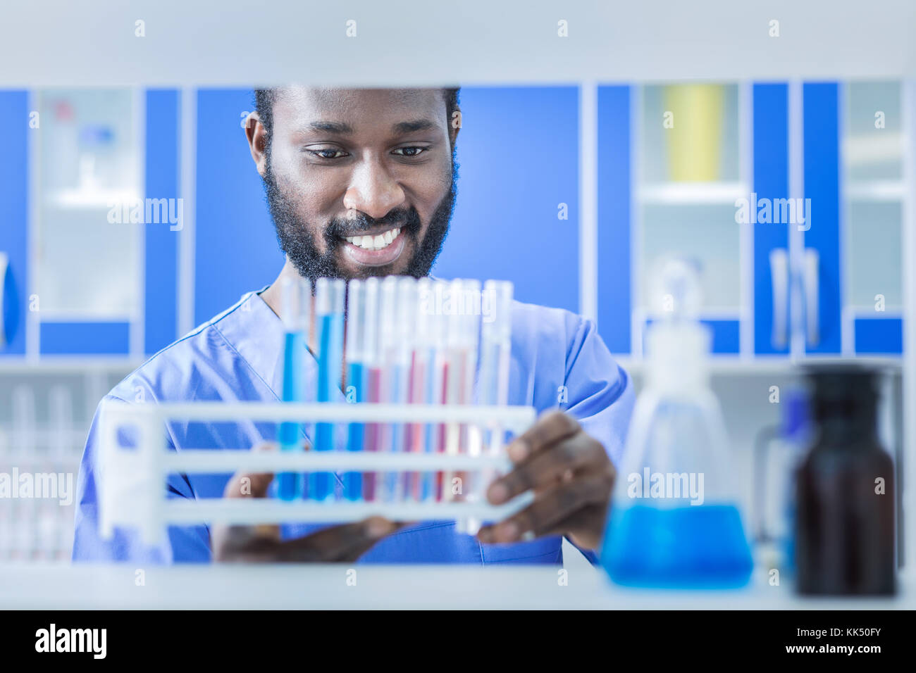 Positive nice scientist working in the chemical lab Stock Photo