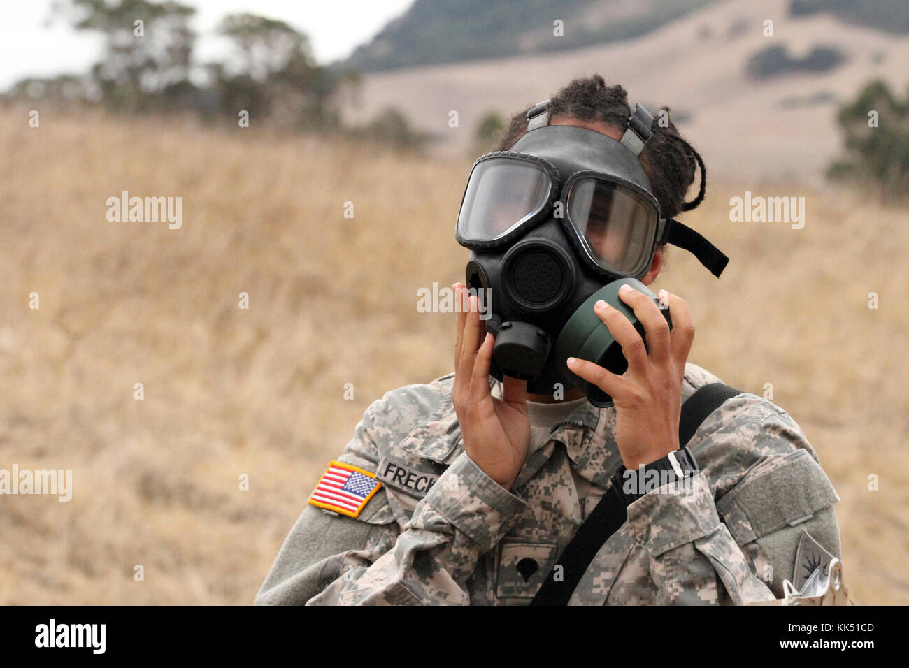 Spc. Emefa Freckleton adjust her protective mask prior to entering a gas chamber Nov. 8 during the California Army National Guard's 2017-18 Best Warrior Competition at Camp San Luis Obispo, California. This was one of the last tests after four competitive days to find California’s Best of the Best. (Army National Guard photo by Staff Sgt. Eddie Siguenza) Stock Photo