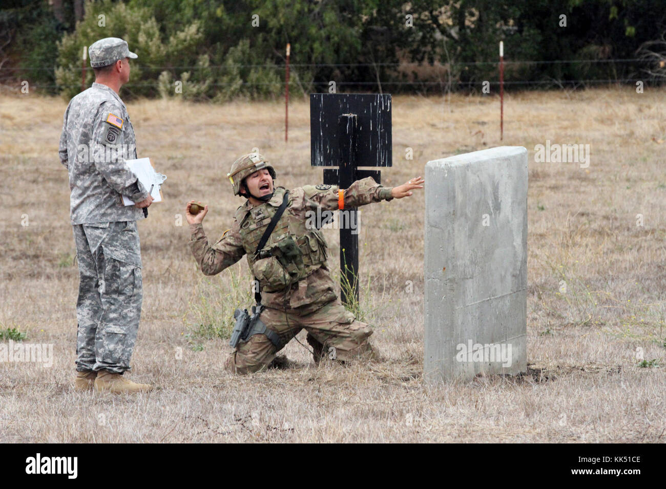 Sgt. George Ruiz shouts “Frag out!” and prepares to throw a grenade simulator Nov. 8 during the California Army National Guard's 2017-18 Best Warrior Competition at Camp San Luis Obispo, California. This was one of the last tests after four competitive days to find California’s Best of the Best. (Army National Guard photo by Staff Sgt. Eddie Siguenza) Stock Photo