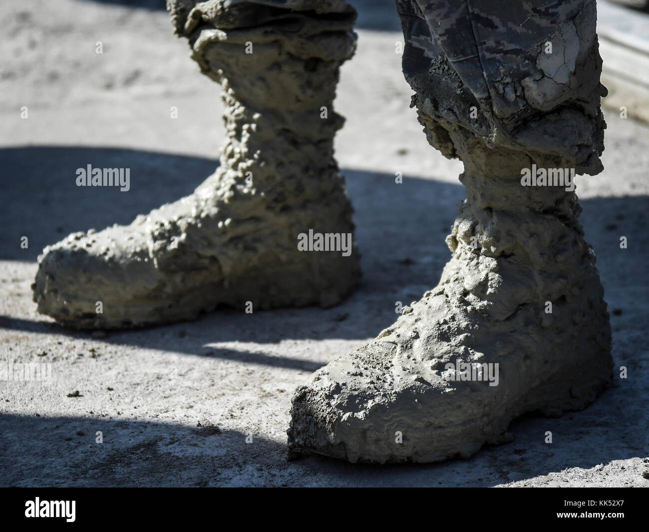 Concrete begins to cure on the boots of U.S. Air Force Airman 1st Class  Ryan Williams, 773d Civil Engineer Squadron, after a Rapid Airfield Damage  Repair training exercise at Gwangju Air Base,