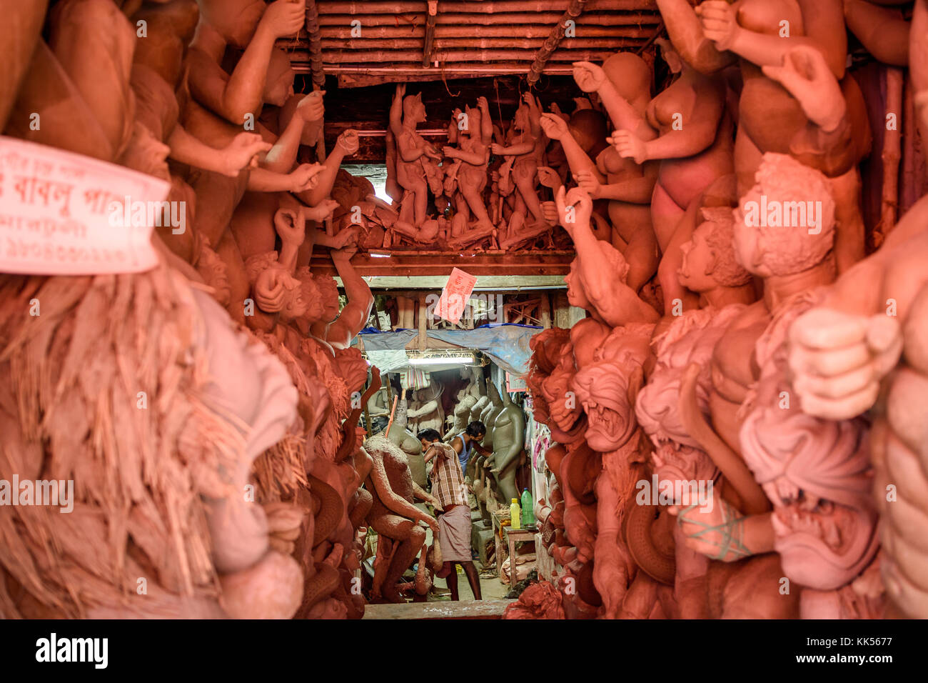 An artisan is busy in his local workshop to finish the unfurnished idol of Durga maa at Kumartuli ,Kolkata, Selective focuse is used. Stock Photo