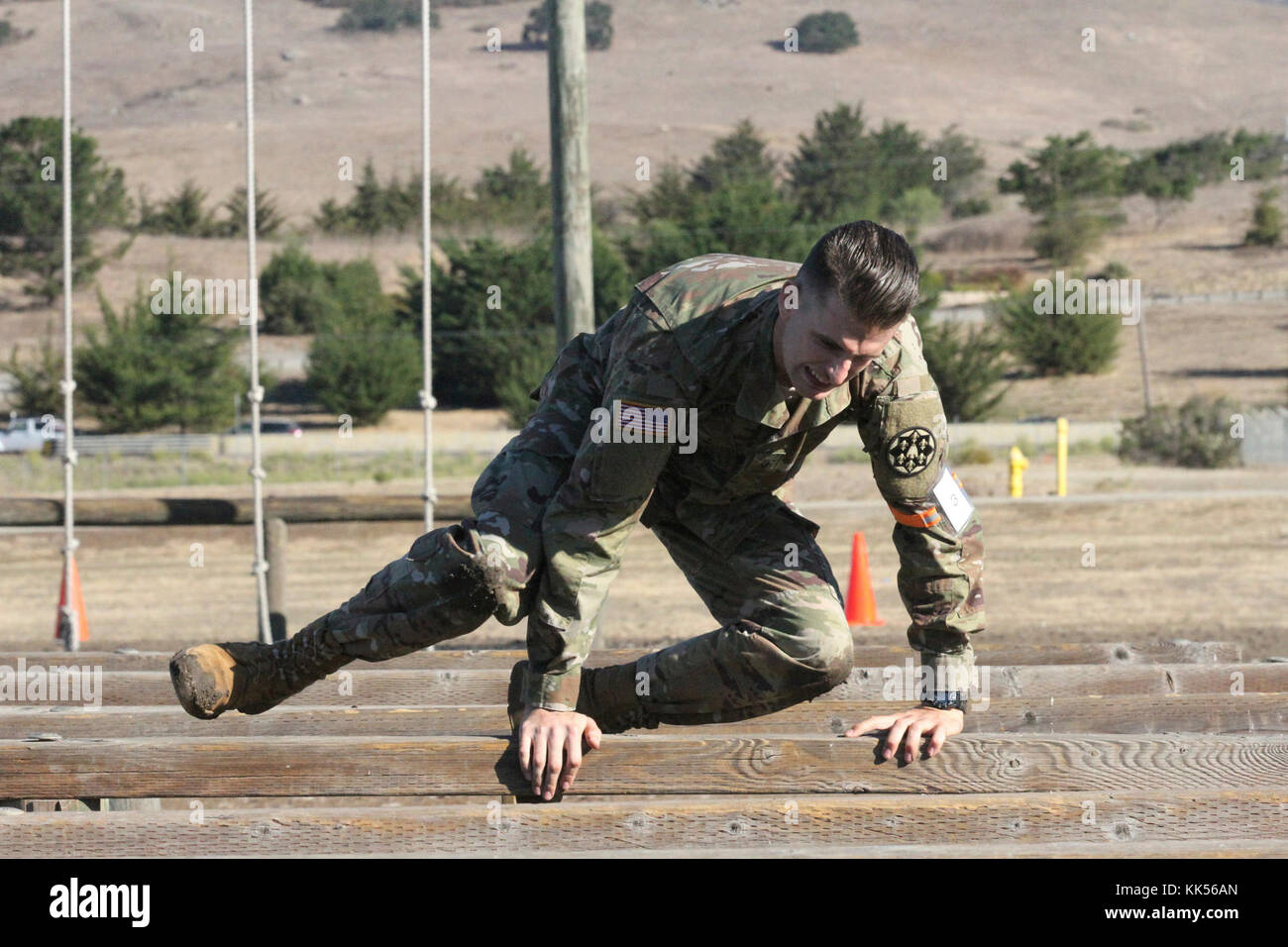 Spc. Devon Witt hurdles an obstacle during Day 3 of a four-day Best Warrior Competition by the California Army National Guard at Camp San Luis Obispo, California. (Army National Guard photo by Staff Sgt. Eddie Siguenza) Stock Photo