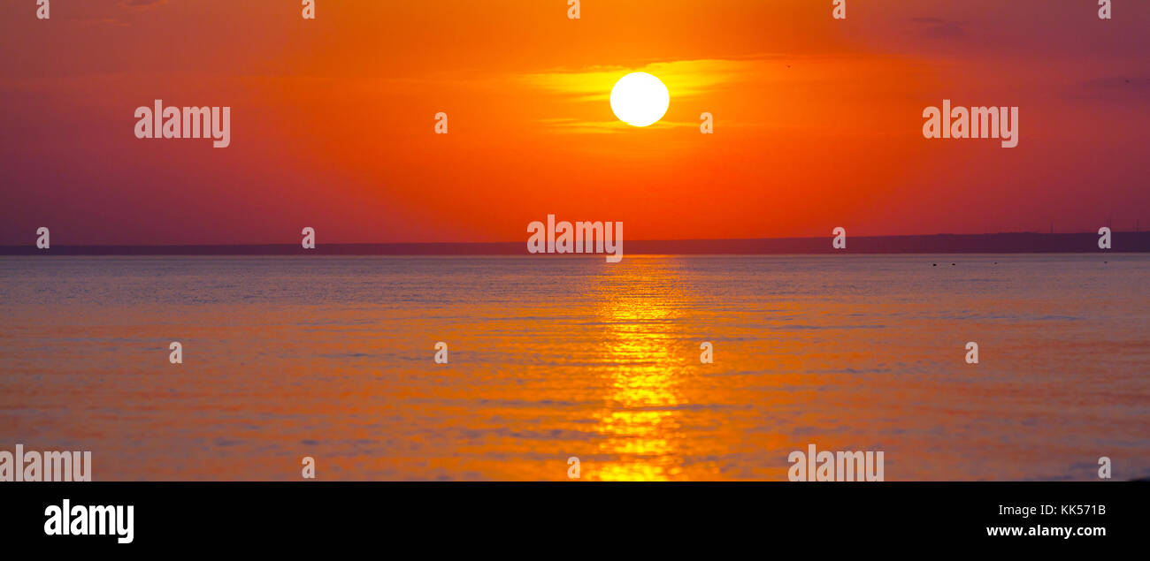 Scenic sunset at the sea coast Stock Photo - Alamy