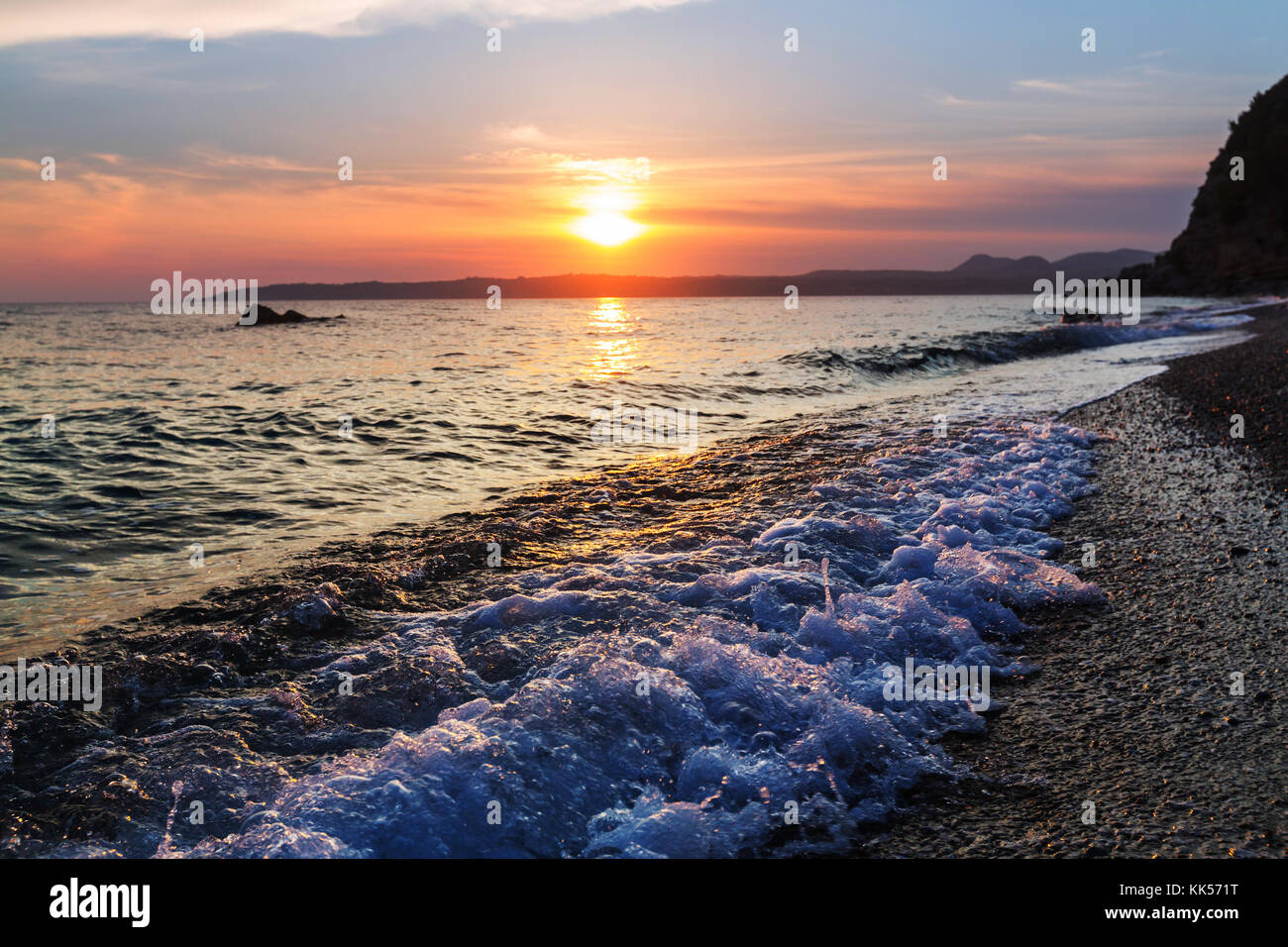 Scenic sunset at the sea coast Stock Photo - Alamy