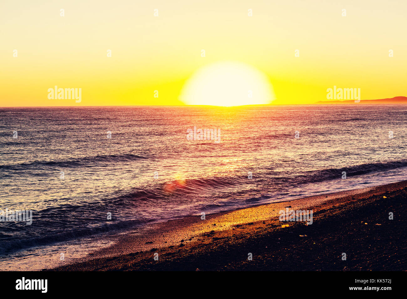 Scenic sunset at the sea coast Stock Photo - Alamy
