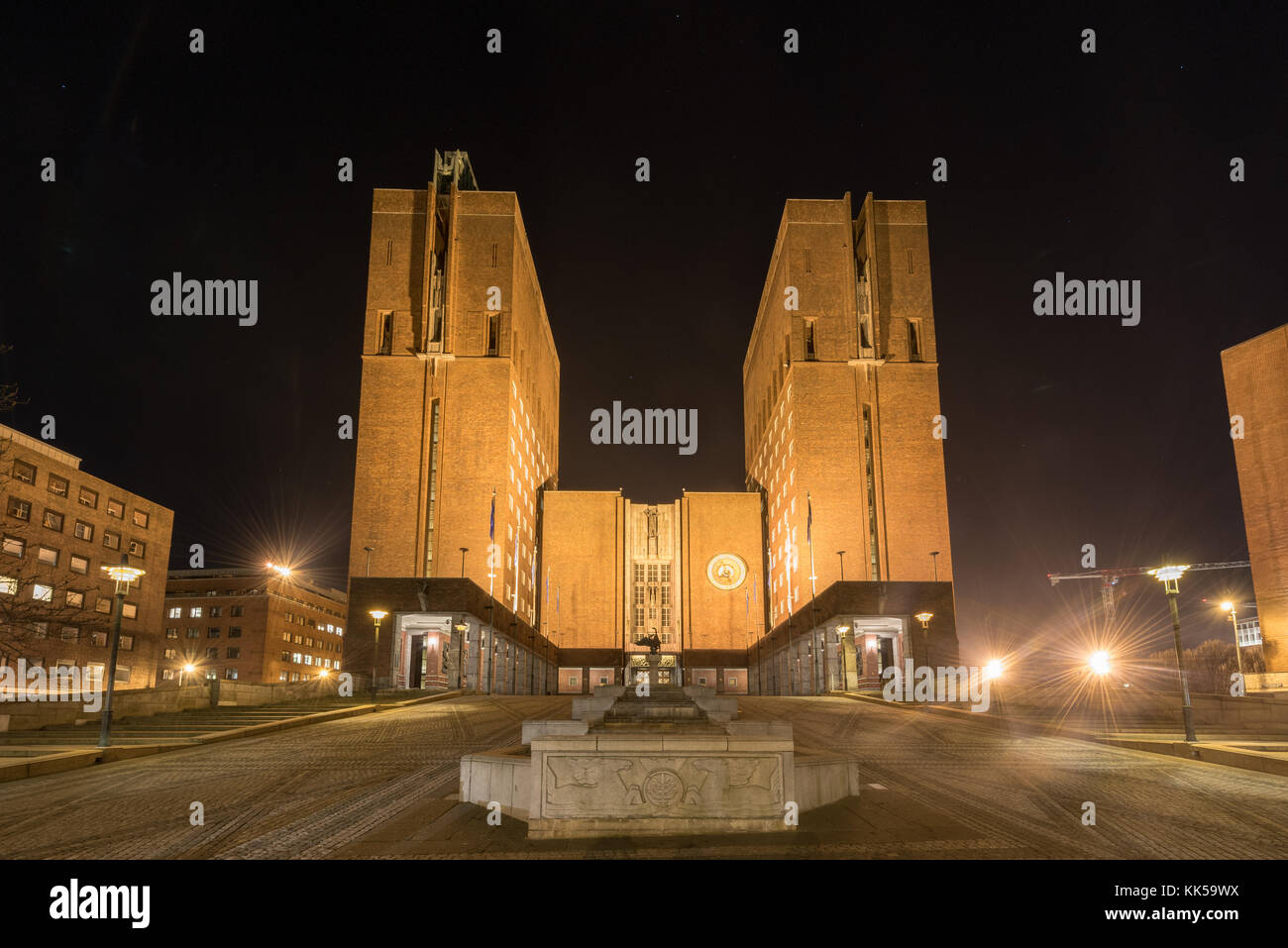 Oslo City Hall (Norwegian: Oslo radhus) illuminated at night. It houses the city council, city administration, and art studios and galleries. Stock Photo