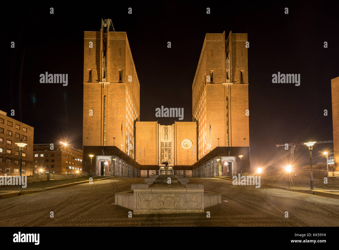 Oslo City Hall (Norwegian: Oslo radhus) illuminated at night. It houses the city council, city administration, and art studios and galleries. Stock Photo