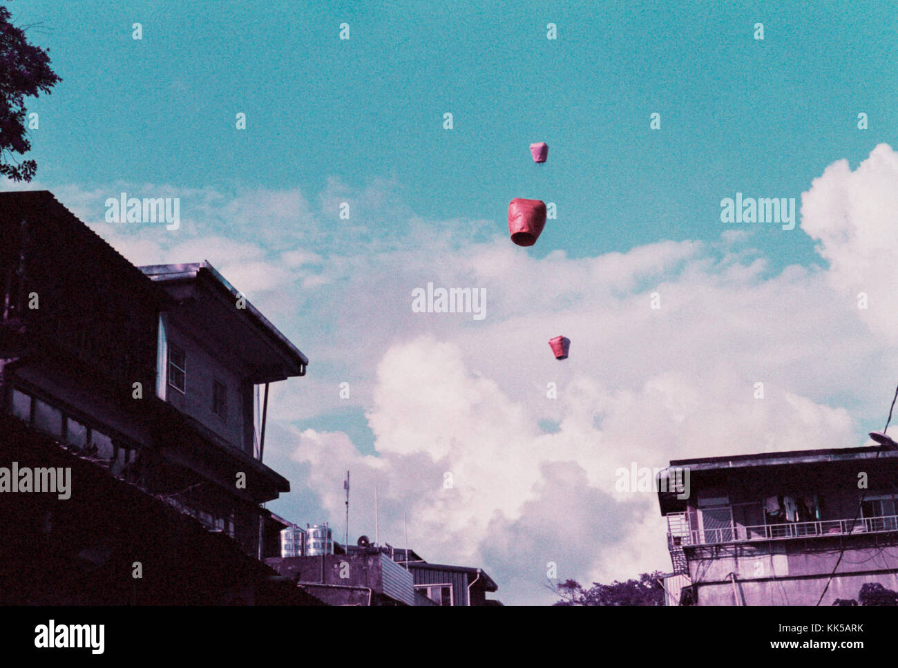 Three Paper Lanterns floating away in the sky in Taiwan Stock Photo