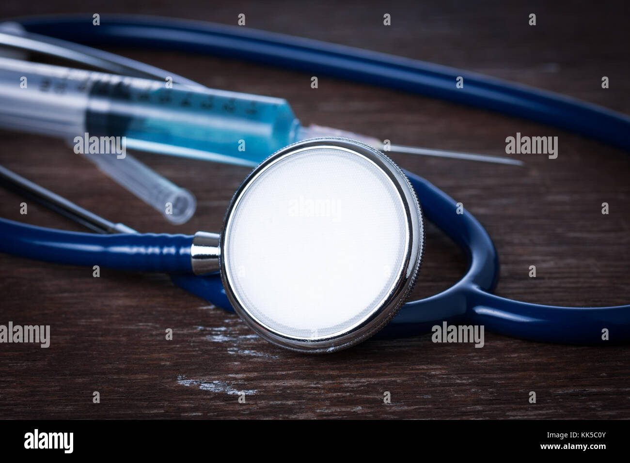 Medical concept , Stethoscope with syringe on wood table Stock Photo ...