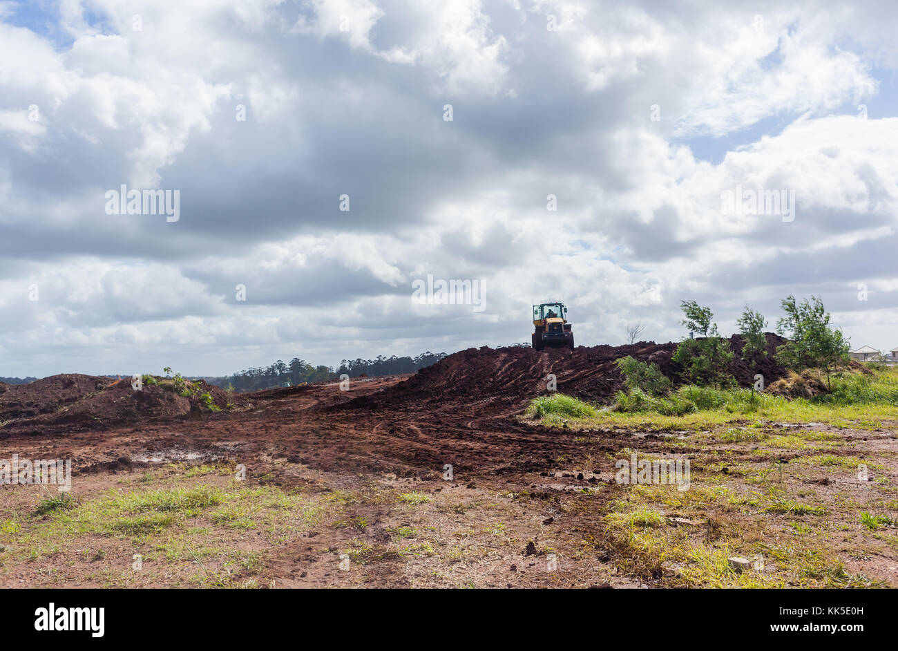 Industrial earthworks grader dozer bucket machine on building construction site. Stock Photo