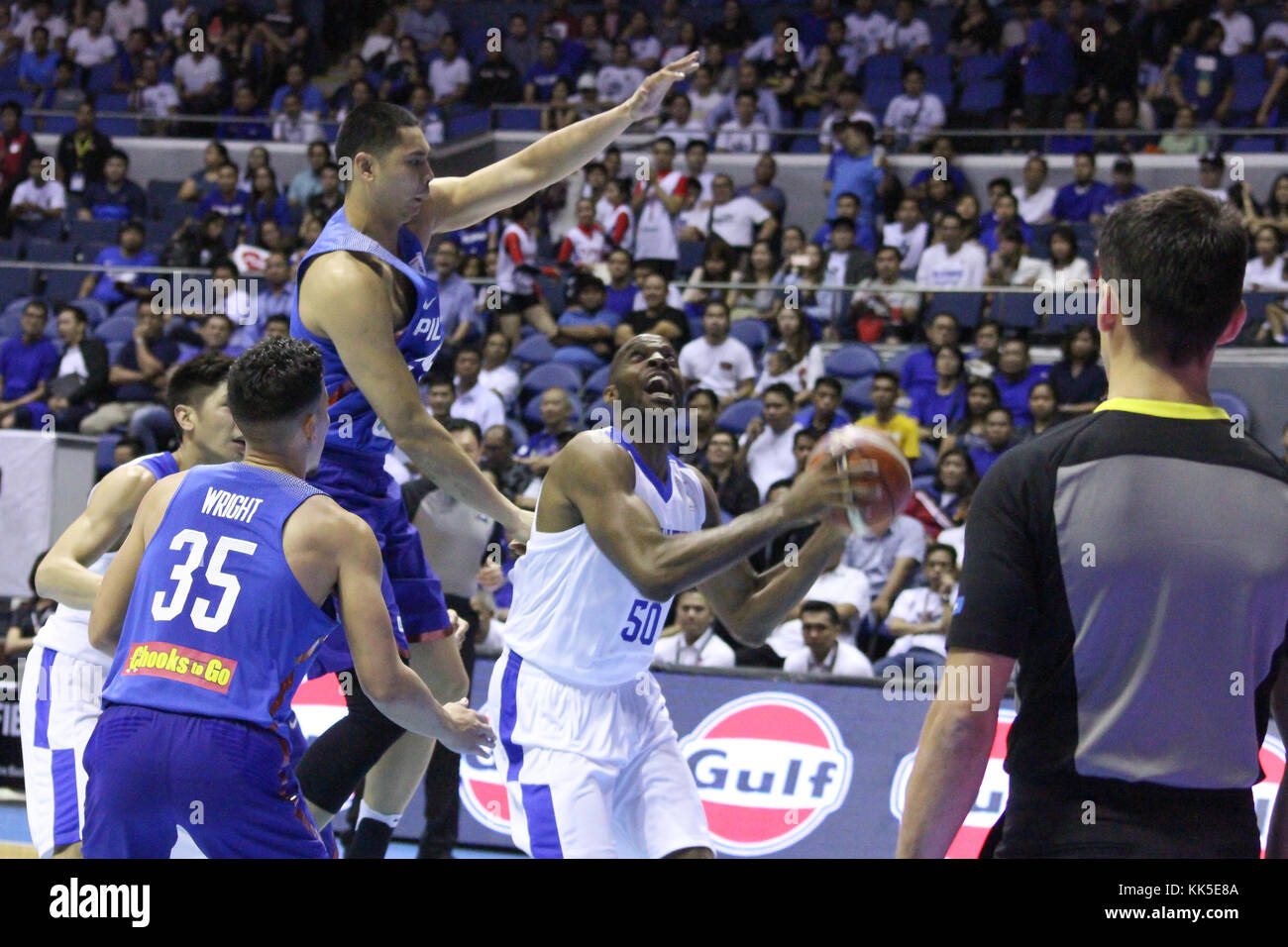 Quezon City, Philippines. 27th Nov, 2017. Quincy Davis (50) of Chinese Taipei tries to shoot the ball over Japeth Aguilar (25) of the Philippines during their FIBA World Cup Qualifiers Match. Gilas Pilipinas defeated the visiting Chinese Taipei team 90-83 to complete a sweep of their first two assignments in the FIBA 2019 World Cup qualifiers. Credit: Dennis Jerome Acosta/ Pacific Press/Alamy Live News Stock Photo