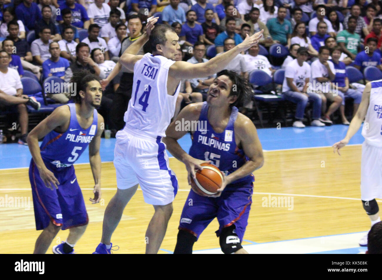 Quezon City, Philippines. 27th Nov, 2017. Junemar Fajardo (15) of the Philippines tries to shoot the ball over Wen-Cheng Tsai (14) of Chines Taipei during their FIBA World Cup Qualifying Match. Gilas Pilipinas defeated the visiting Chinese Taipei team 90-83 to complete a sweep of their first two assignments in the FIBA 2019 World Cup qualifiers. Credit: Dennis Jerome Acosta/ Pacific Press/Alamy Live News Stock Photo