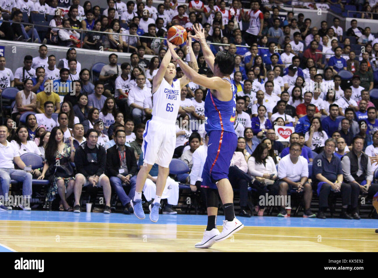 Quezon City, Philippines. 27th Nov, 2017. Kai-Yan Lee (66) of Chinese Taipei tries to shoot the ball over Junemar Fajardo (15) of the Philippines. Gilas Pilipinas defeated the visiting Chinese Taipei team 90-83 to complete a sweep of their first two assignments in the FIBA 2019 World Cup qualifiers. Credit: Dennis Jerome Acosta/ Pacific Press/Alamy Live News Stock Photo