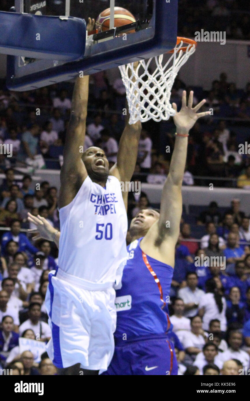 Quezon City, Philippines. 27th Nov, 2017. Quincy Davis III (50) of Chinese Taipei tries to dunk the ball over Junemar Fajardo (15) of the Philippines. Gilas Pilipinas defeated the visiting Chinese Taipei team 90-83 to complete a sweep of their first two assignments in the FIBA 2019 World Cup qualifiers. Credit: Dennis Jerome Acosta/ Pacific Press/Alamy Live News Stock Photo