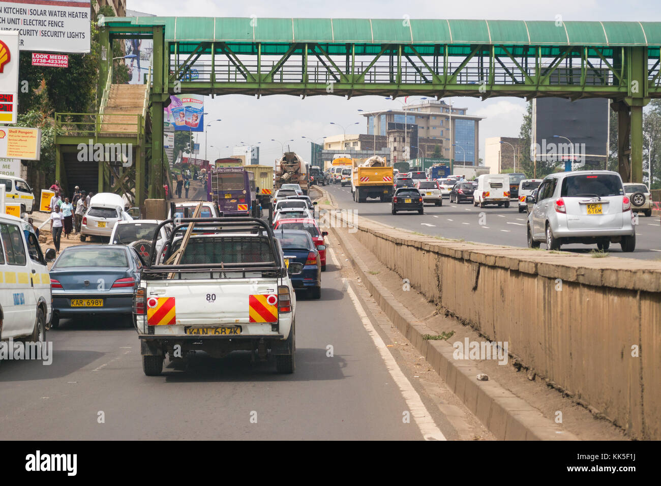 Typical heavy traffic on the Embu Nairobi Highway leading in to Nairobi city with vehicles waiting to merge on to the road, Kenya, East Africa Stock Photo