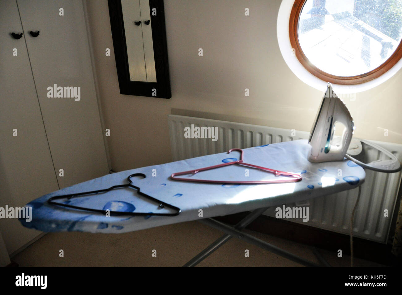 iron on ironing board Stock Photo Alamy