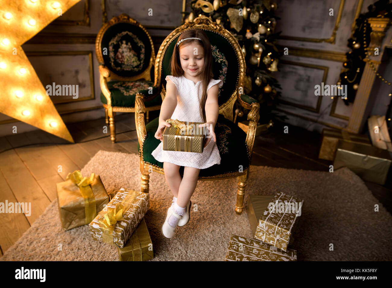 Happy little smiling girl with christmas gift box Stock Photo - Alamy