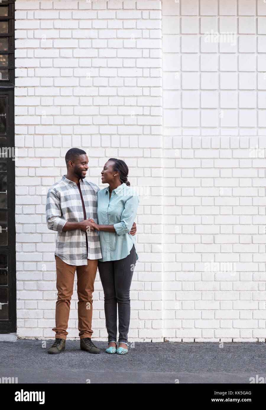 Smiling young African couple standing together in the city Stock Photo
