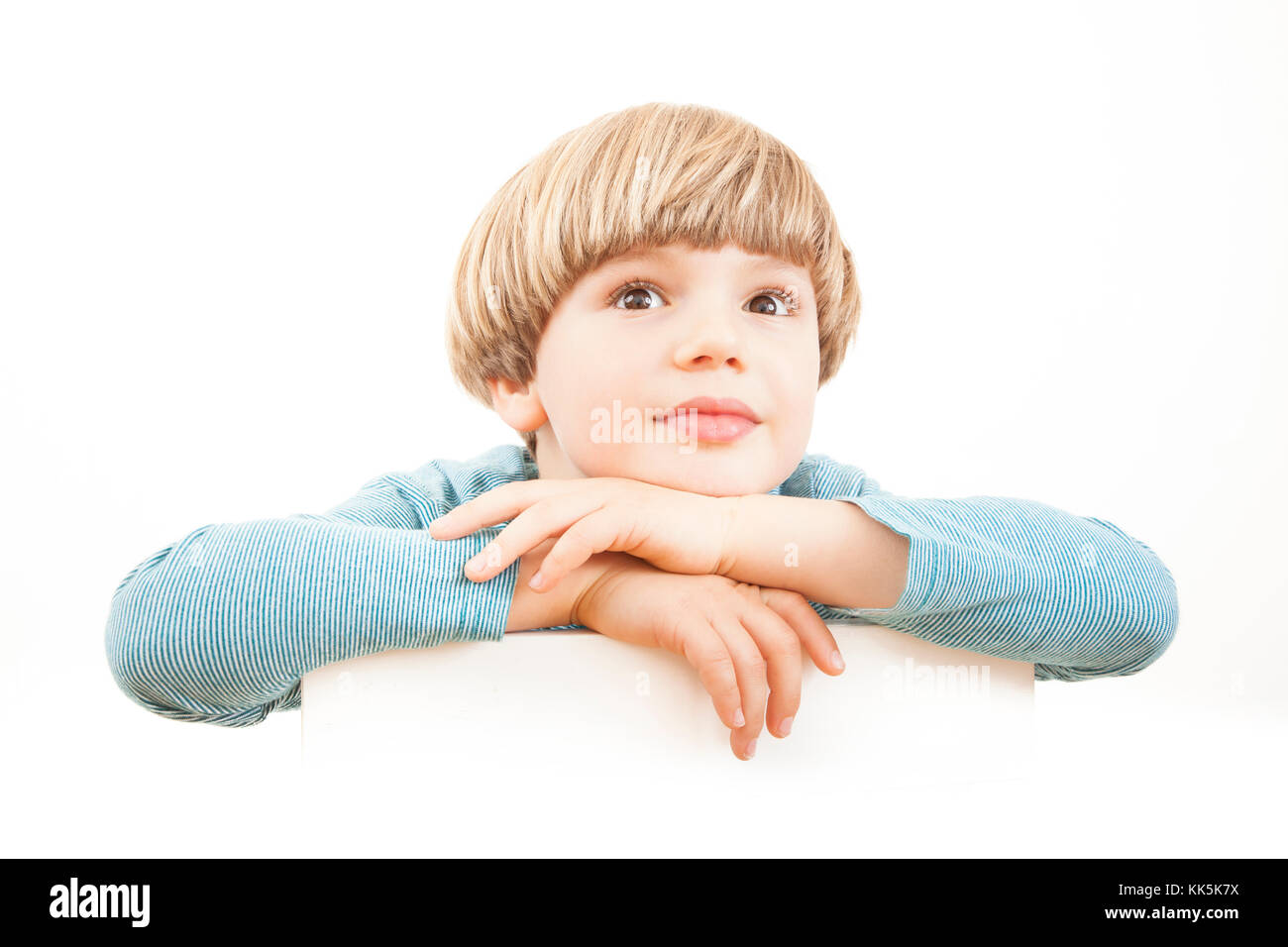 Imaginative and  curious boy - Thoughtful dreamer – Daydreaming - Looking up on white background – Isolated portrait Stock Photo