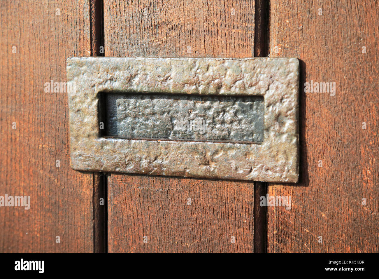 Close up of metal letter box in wooden front door, UK Stock Photo Alamy